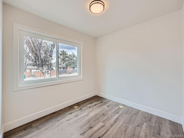 spare room with light hardwood / wood-style floors