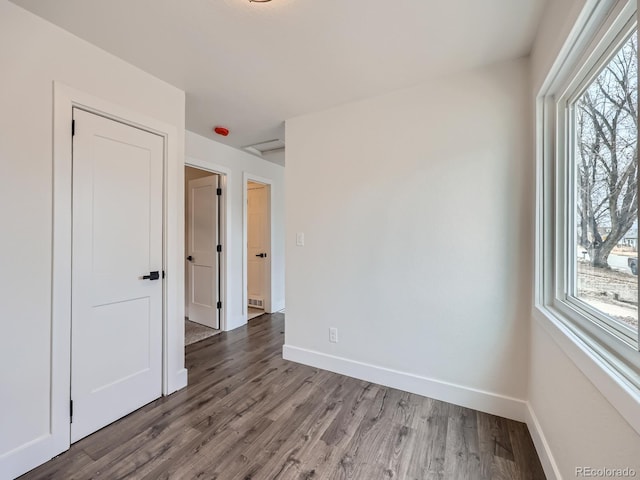 spare room featuring wood-type flooring