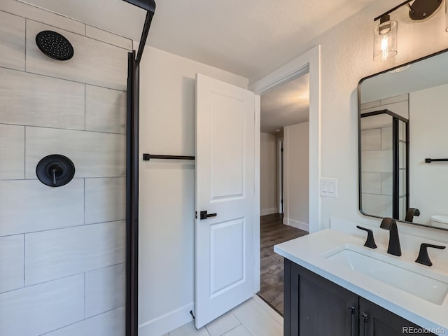 bathroom with vanity, an enclosed shower, and hardwood / wood-style flooring