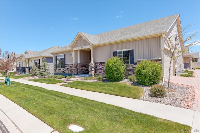 6717 Golden Briar Ln, Colorado Springs, CO 80927 - single story home with stone siding, a front yard, and roof with shingles