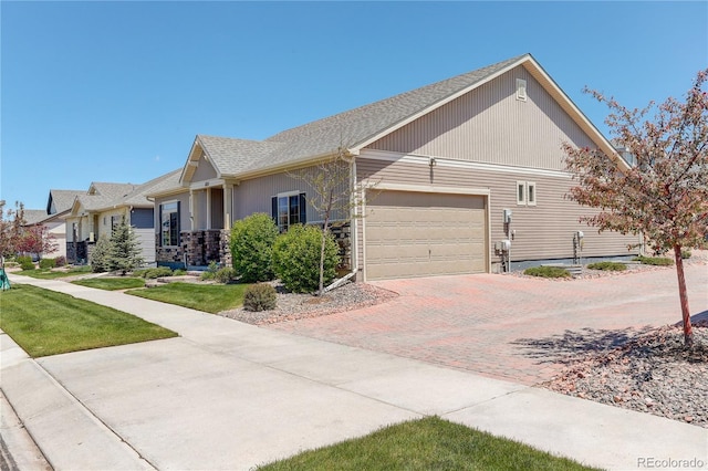 6717 Golden Briar Ln, Colorado Springs, CO 80927 - view of property exterior with an attached garage, decorative driveway, stone siding, and a shingled roof