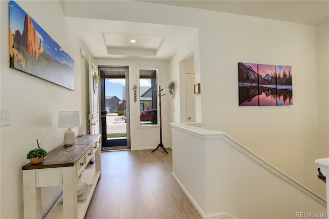 6717 Golden Briar Ln, Colorado Springs, CO 80927 - hallway with wood finished floors, a tray ceiling, and baseboards