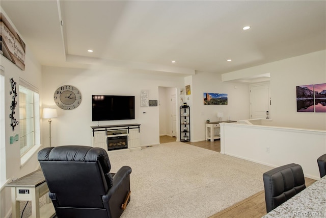 6717 Golden Briar Ln, Colorado Springs, CO 80927 - living area featuring recessed lighting, wood finished floors, a glass covered fireplace, and baseboards