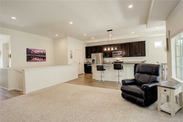 6717 Golden Briar Ln, Colorado Springs, CO 80927 - living area with recessed lighting, light wood-style flooring, light colored carpet, and baseboards