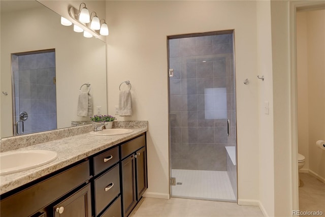 6717 Golden Briar Ln, Colorado Springs, CO 80927 - full bath with double vanity, a stall shower, toilet, tile patterned floors, and baseboards