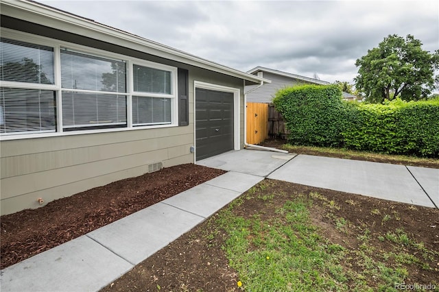 740 Moline St, Aurora, CO 80010 - view of property exterior featuring crawl space, an attached garage, and driveway