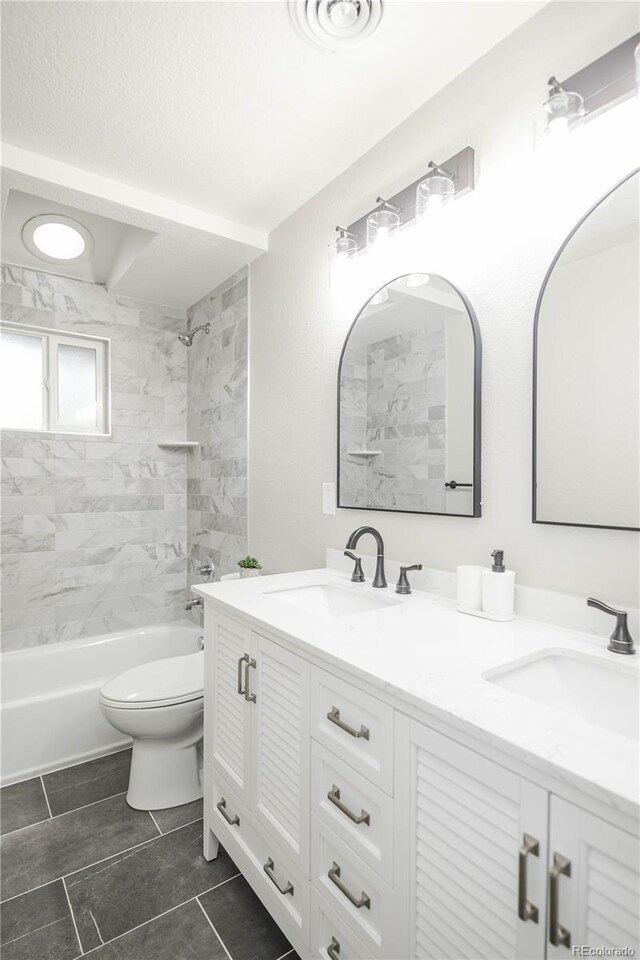 740 Moline St, Aurora, CO 80010 - full bath featuring toilet, double vanity, shower / bathtub combination, and tile patterned flooring