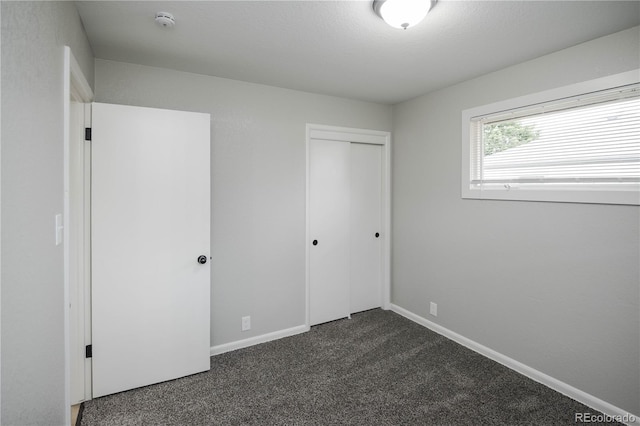 740 Moline St, Aurora, CO 80010 - unfurnished bedroom featuring dark carpet, a closet, and baseboards