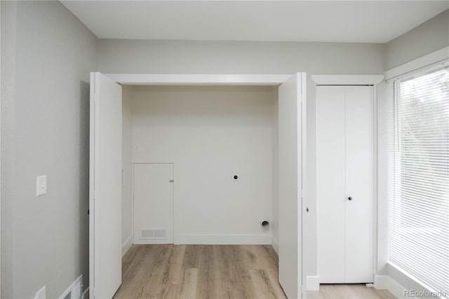 740 Moline St, Aurora, CO 80010 - laundry area featuring electric dryer hookup, light wood finished floors, and baseboards