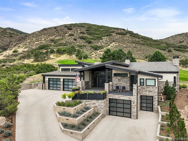 view of front of house with a mountain view and a garage