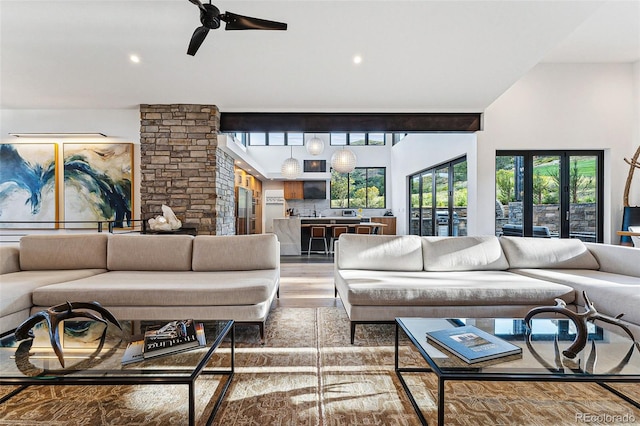 living room featuring ceiling fan and hardwood / wood-style flooring