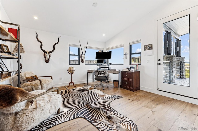 office area featuring lofted ceiling and light hardwood / wood-style floors