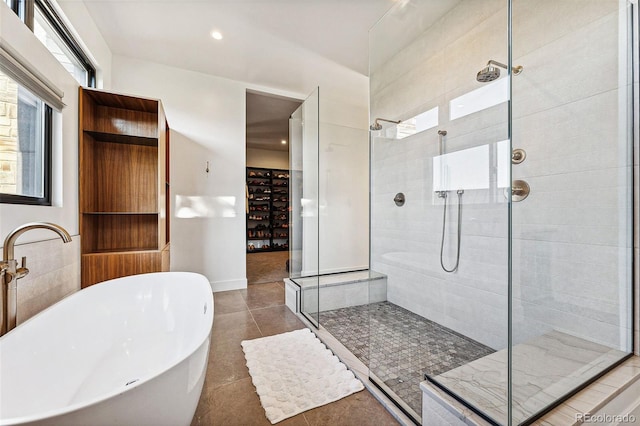 bathroom with separate shower and tub and tile patterned floors