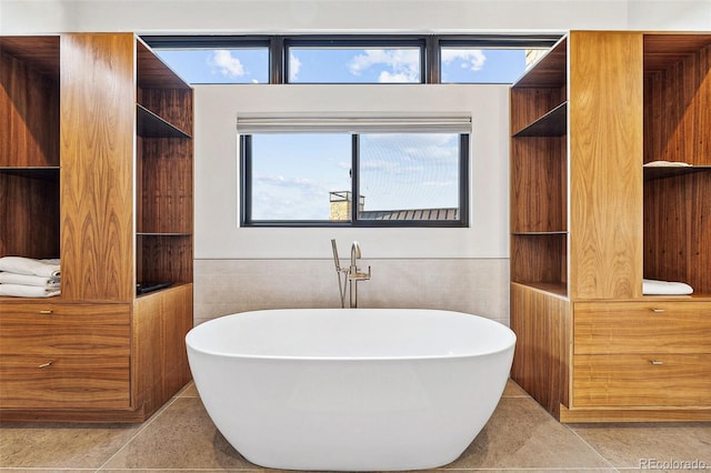 bathroom with tile walls and a tub