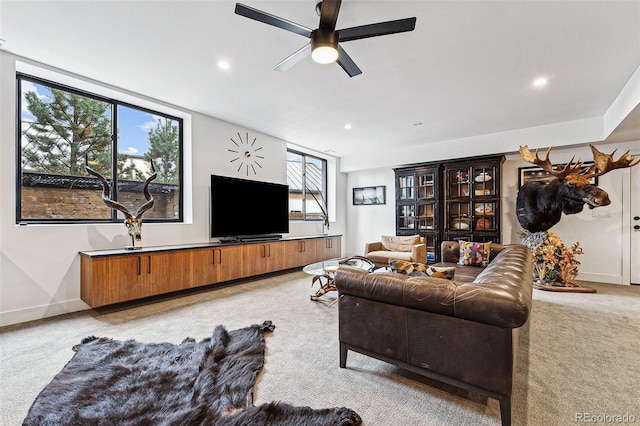 carpeted living room with ceiling fan