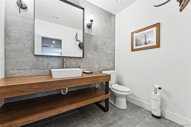 bathroom with vanity, tile walls, toilet, and tile patterned floors