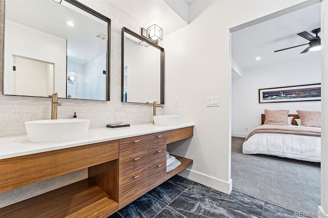 bathroom featuring ceiling fan, vanity, and walk in shower