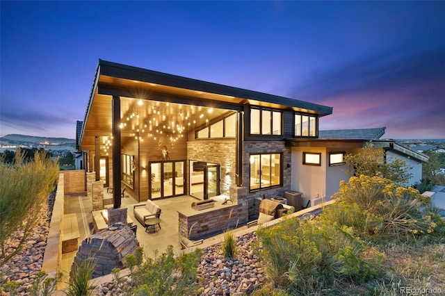 back house at dusk with a patio