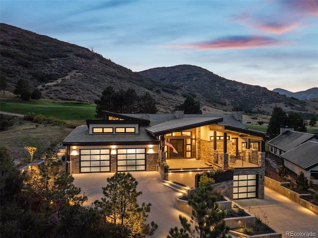 view of front of property with a mountain view and a garage