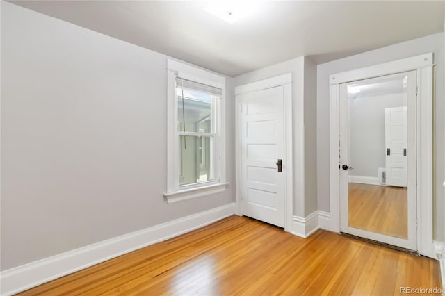 unfurnished room featuring light wood-style flooring and baseboards
