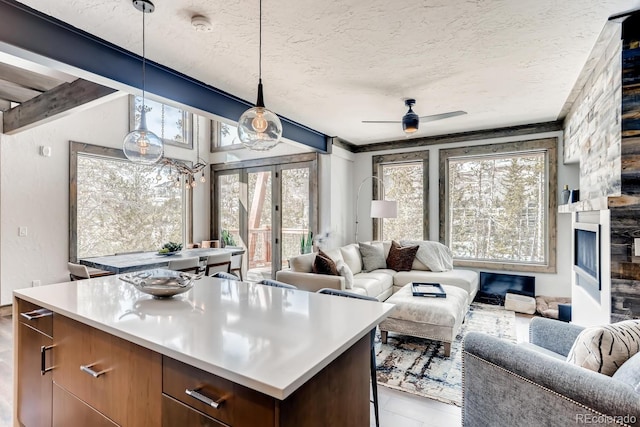 kitchen featuring pendant lighting, open floor plan, and light countertops