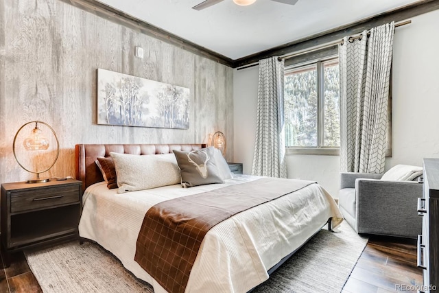 bedroom with dark wood-style floors, ceiling fan, and crown molding