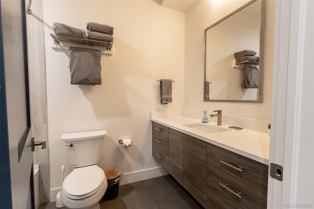 bathroom with toilet, tile patterned floors, baseboards, and vanity