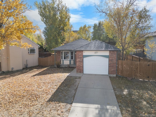 view of front of property featuring a garage and a wall mounted AC