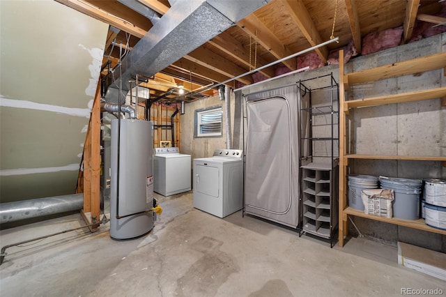 basement featuring water heater and separate washer and dryer