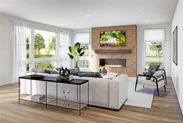 living room featuring wood finished floors, healthy amount of natural light, a brick fireplace, and recessed lighting