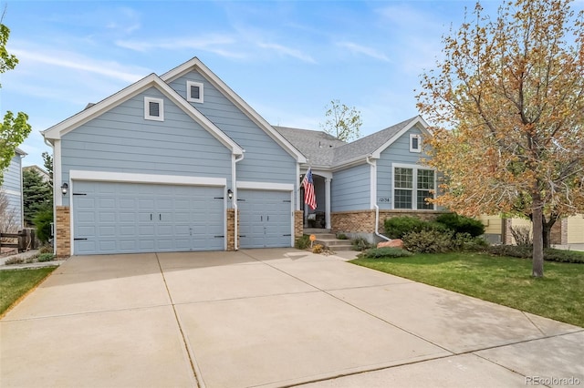 view of front of home featuring an attached garage, concrete driveway, a front lawn, and brick siding