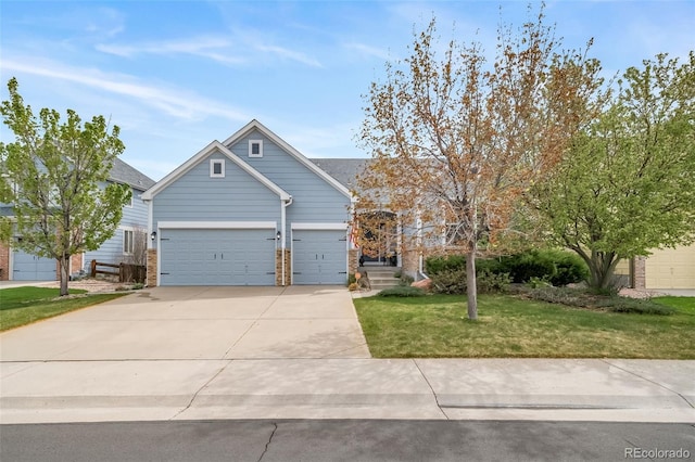 craftsman-style house featuring concrete driveway, brick siding, an attached garage, and a front yard