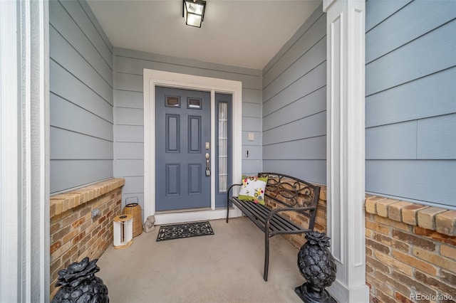 view of exterior entry featuring covered porch