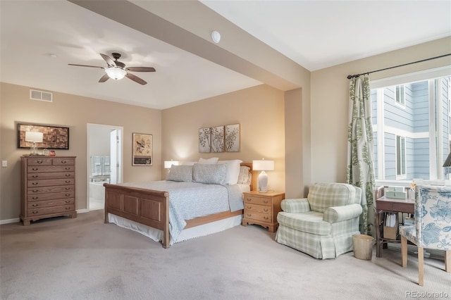bedroom with ceiling fan, ensuite bath, carpet floors, baseboards, and visible vents