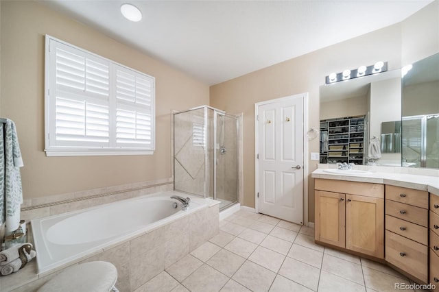 bathroom with vanity, tile patterned floors, a bath, and a shower stall