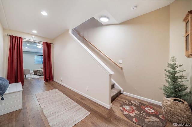 interior space featuring wood-type flooring, recessed lighting, stairs, and baseboards