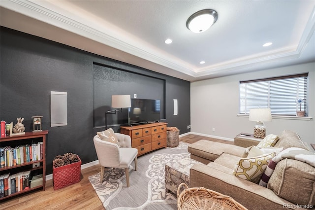 living area with a raised ceiling, baseboards, recessed lighting, and wood finished floors