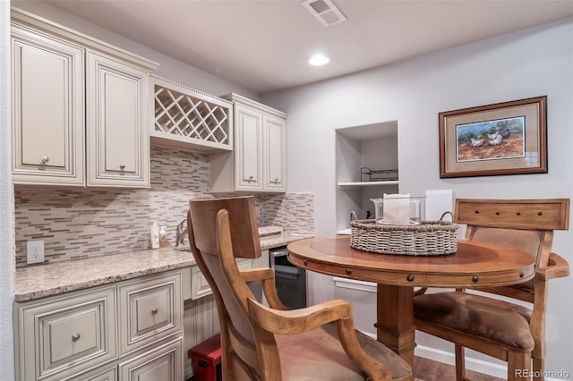 dining space featuring built in study area, recessed lighting, and visible vents