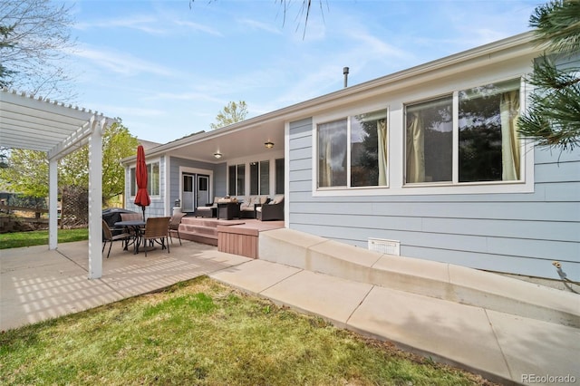 rear view of house with a pergola, an outdoor living space, and a patio