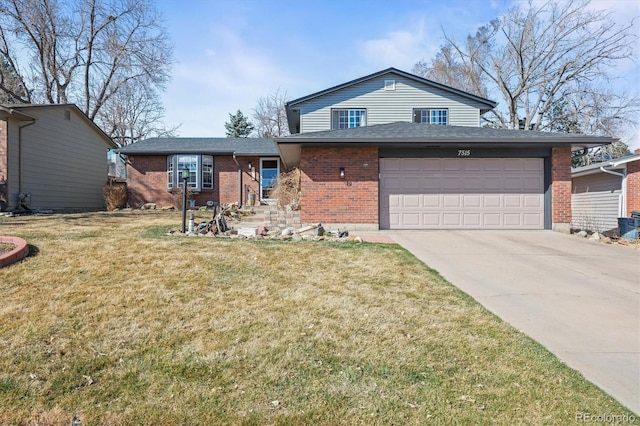 split level home featuring a front yard, brick siding, driveway, and a shingled roof