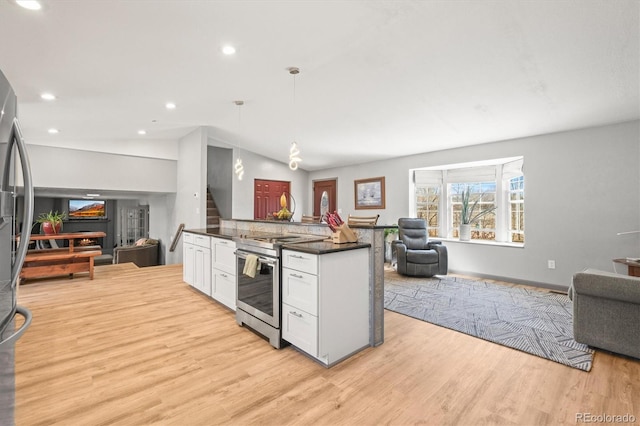 kitchen with dark countertops, open floor plan, lofted ceiling, stainless steel range with electric cooktop, and light wood-style floors