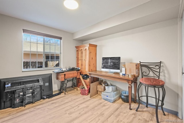 office area featuring baseboards and wood finished floors