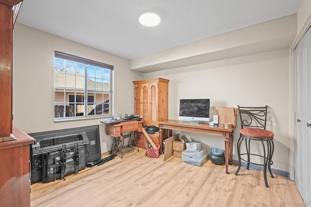 office space with baseboards and wood finished floors