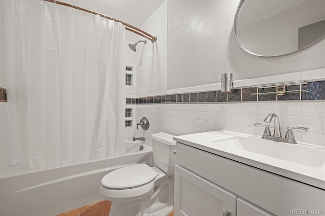 bathroom with shower / bathtub combination with curtain, toilet, tile walls, tile patterned flooring, and vanity