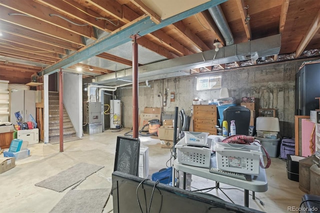 unfinished below grade area featuring stairs, heating unit, and water heater