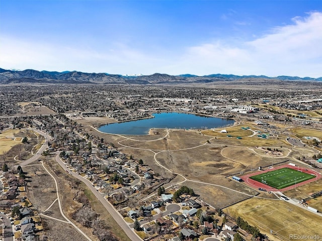 drone / aerial view featuring a water and mountain view