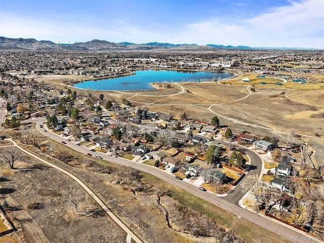 birds eye view of property with a water and mountain view