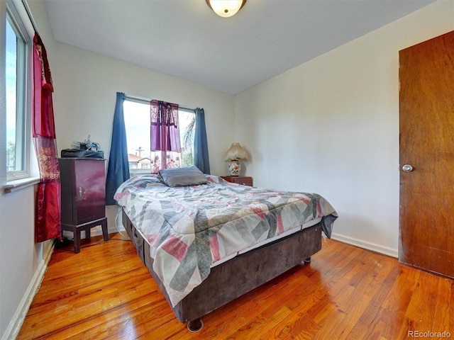 675 S Quivas St, Denver, CO 80223 - bedroom with baseboards and light wood finished floors