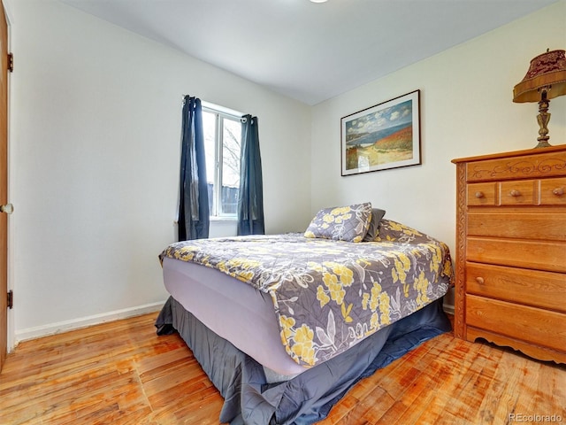 675 S Quivas St, Denver, CO 80223 - bedroom with baseboards and wood finished floors