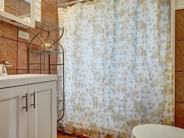 675 S Quivas St, Denver, CO 80223 - bathroom with vanity, a shower with curtain, and toilet